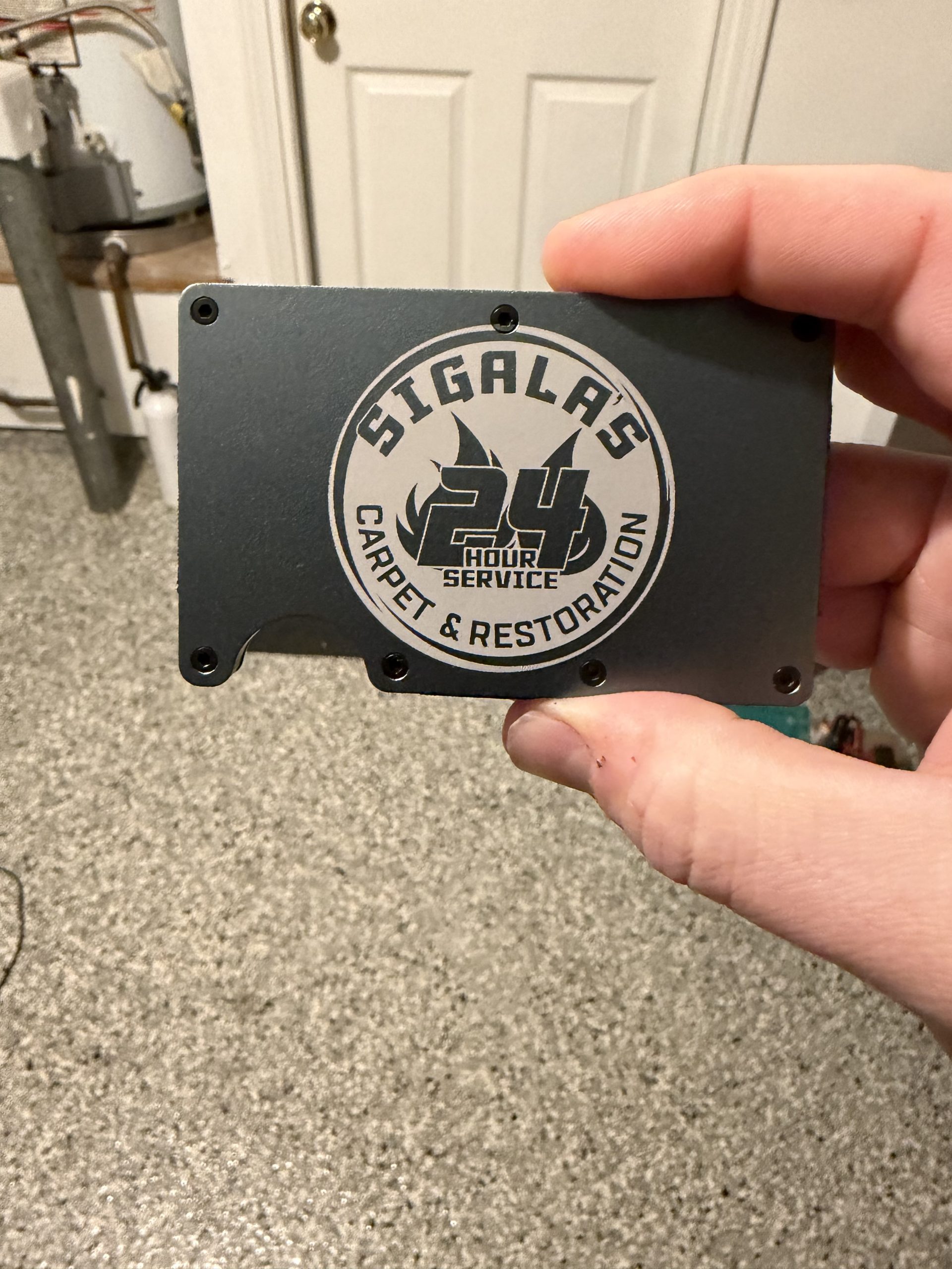 Engraved wallet with Sigalas logo close-up